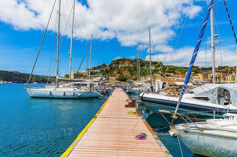 Jetty with anchored sailing yachts, harbour of Port Azzurro, Elba Island, Tuscan Archipelago National Park, Tuscany, Italy