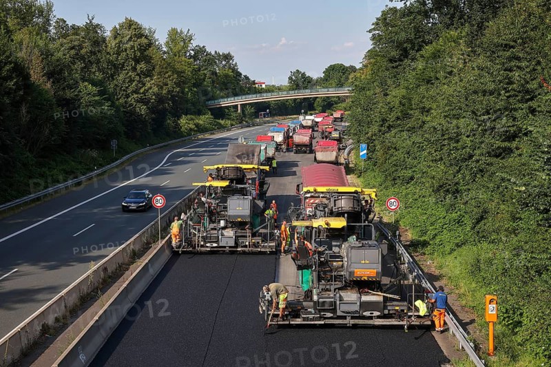 Essen, North Rhine-Westphalia, Germany, Road construction, Asphalt pavers and road rollers lay new, open-pored, whisper asphalt on the A52 motorway, here between the Essen-Kettwig and Essen-Rüttenscheid junctions in the direction of Dortmund