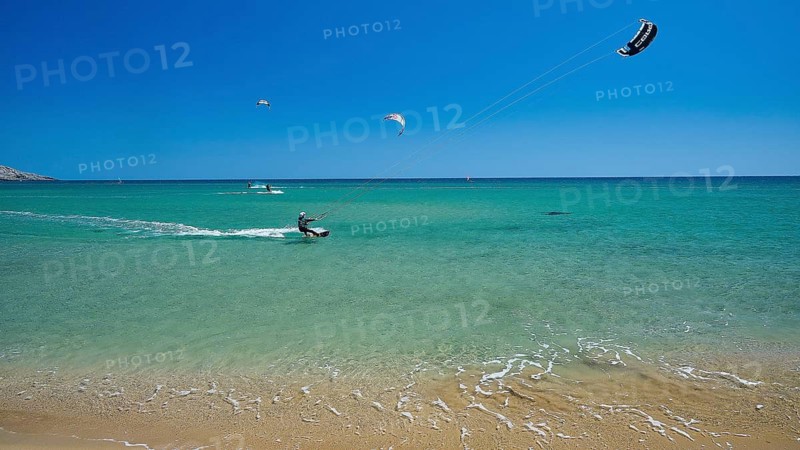 Kitesurfer on turquoise sea near the calm beach under clear sky, surfers paradise, kitesurfer, windsurfer, Prasonisi, island in the south of Rhodes, Rhodes, Dodecanese, Greek Islands, Greece