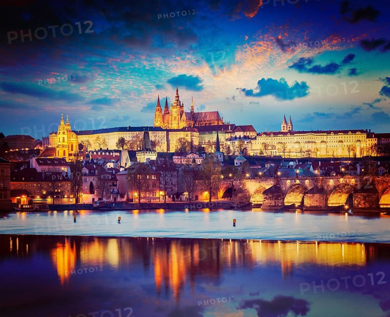 Vintage retro hipster style travel image of Prague Europe concept background, view of Charles Bridge and Prague Castle in twilight. Prague, Czech Republic