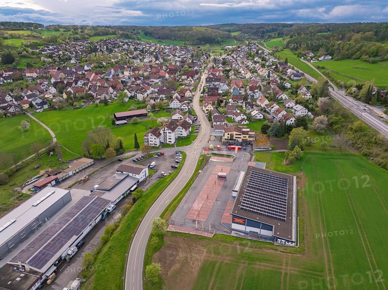 View of a village with solar panels and several buildings along a main road, Ostelsheim, Calw district, Germany