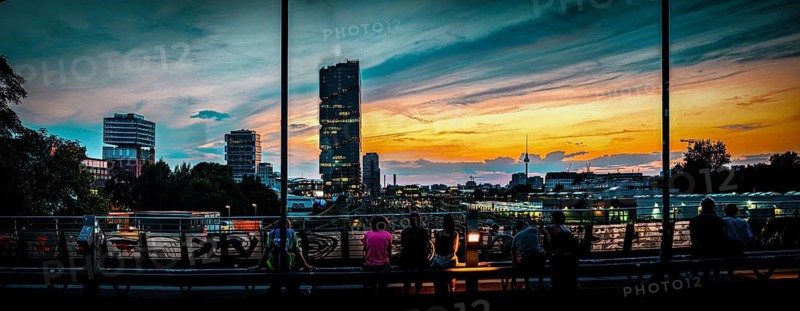 Panoramic view, atmospheric scene, people enjoying the view from the Modersohn Bridge, wide-angle view of Berlin skyline, EDGE East Side high-rise building, television tower in the background at sunset, Friedrichshain, Berlin