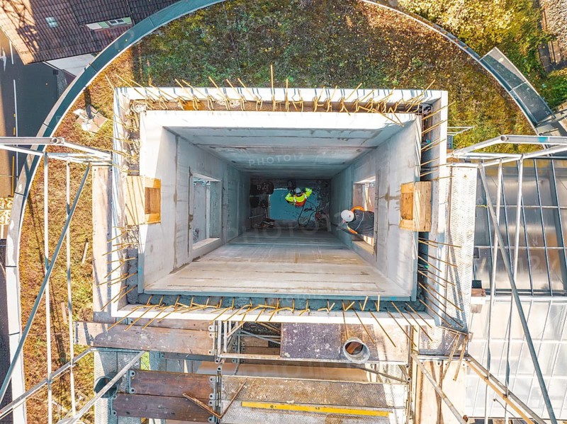 Construction work on a tower with scaffolding, taken from the air in oblique perspective, ZOB Calw reconstruction for Hermann Hessebahn, Calw, Black Forest, Germany