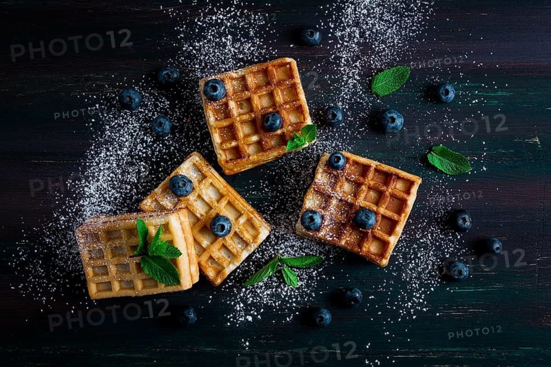 Viennese waffles with blueberries, on a dark background, breakfast, no people, selective focus