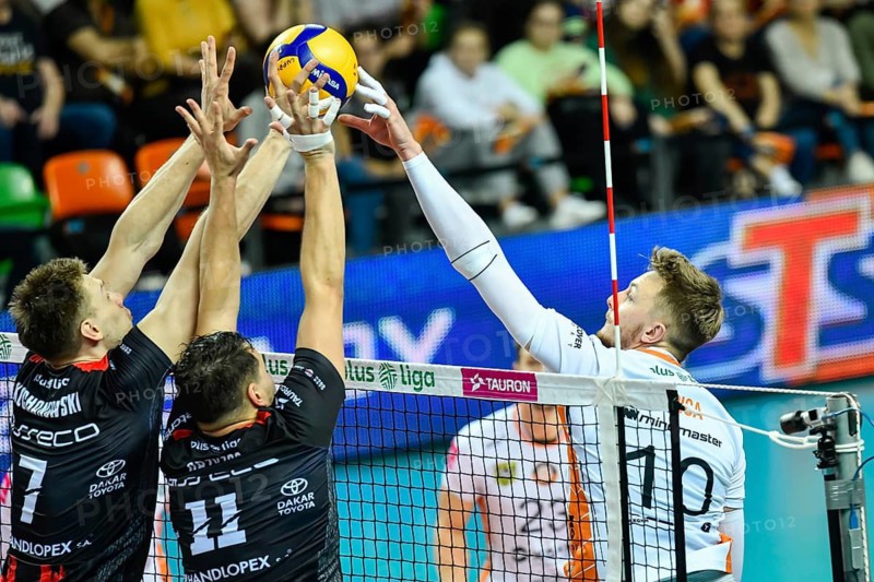 LUBIN, POLAND - OCTOBER 15, 2022: Men's Volleyball Polish PlusLiga match Cuprum Lubin VS Asseco Resovia Rzeszow 0:3. Block Jakub Kochanowski (L) Fabian Drzyzga (R) attack Remigiusz Kapica.