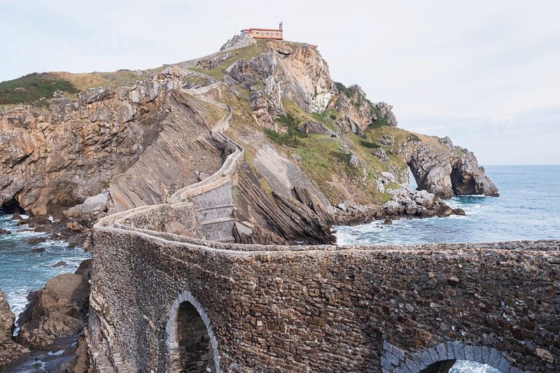 Historic Gaztelugatxe, featuring its iconic hermitage from the 10th century, spans across a rugged islet in Bermeo, Basque Country, Spain, connected by stone bridge