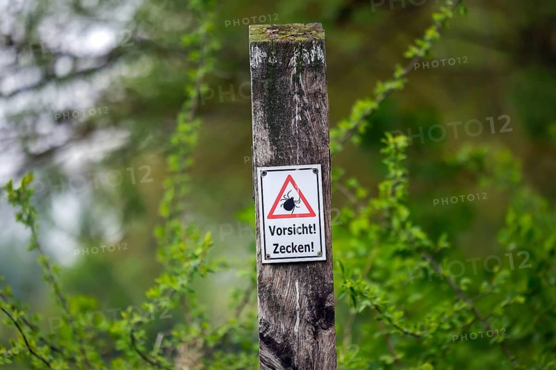 North Rhine-Westphalia, Germany - Caution! Ticks, warning sign on the hiking trail in the Urdenbacher Kämpe nature reserve in Düsseldorf