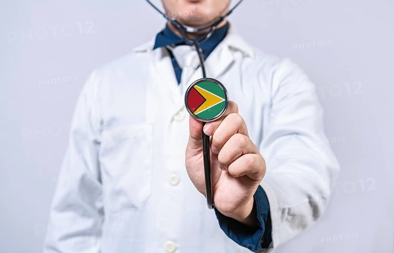 Doctor hands holding stethoscope with Guyana flag. Guyana health and care concept