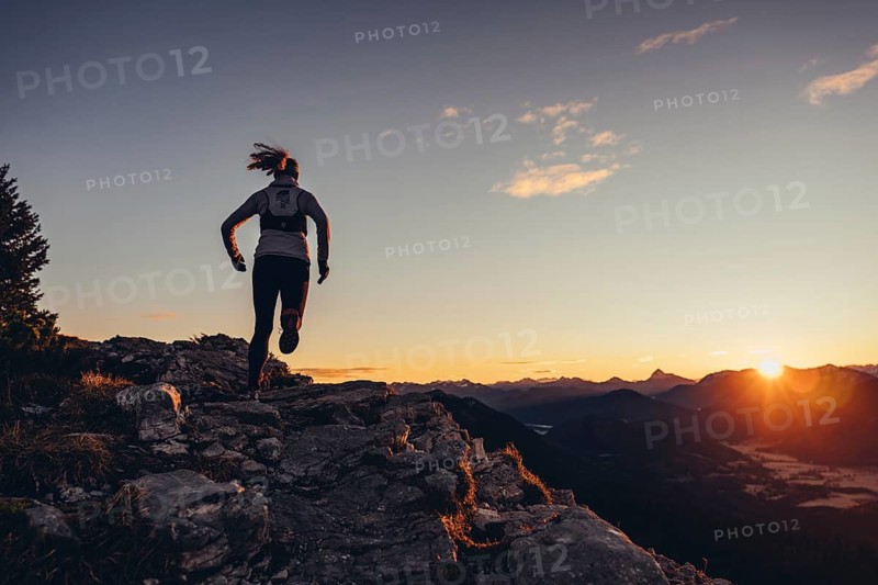 Trail running in autumn on the Jochberg on Lake Walchensee against the wonderful backdrop of the Alps, Bavaria, Germany