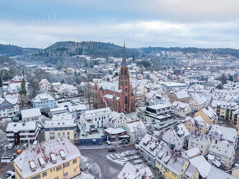 Town view with church and snow-covered roofs, surrounded by winter landscape, Nagold, Black Forest, Germany