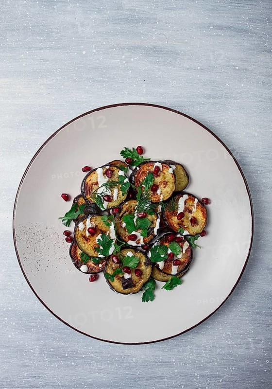 Fried eggplant, with white sauce, pomegranate seeds, top view, no people