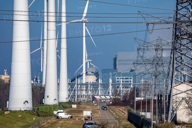 Wind farm and the Eemshaven coal power plant, right, Eemshavencentrale, operated by RWE Generation, one of the 3 large power plants in the Eemshaven energy park, has an output of up to 1.6 GW, Groningen province, the Netherlands