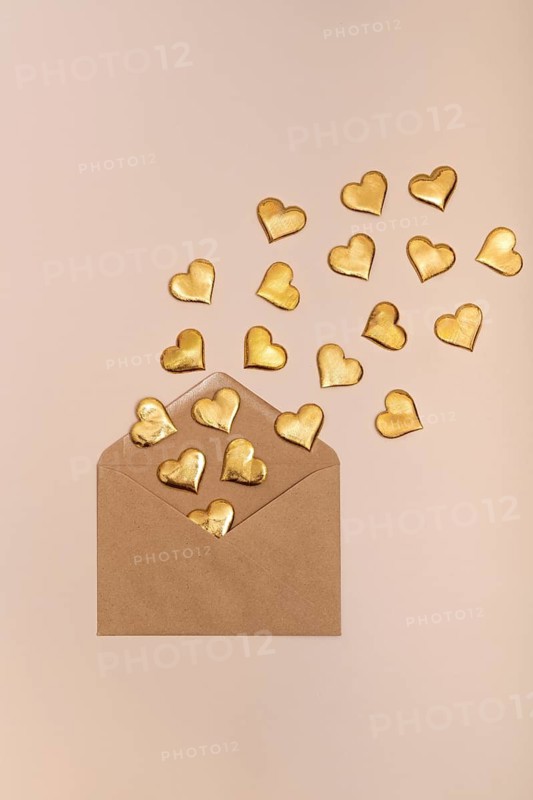 Golden heart shapes emerging from a craft envelope, symbolizing love and celebration, ideal for St. Valentine's Day and romantic occasions
