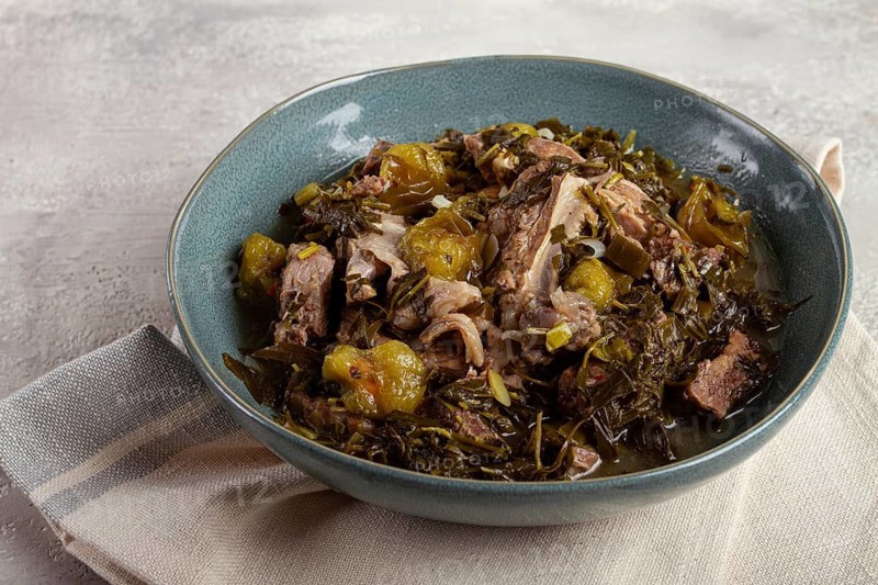 Chakapuli, Georgian dish, stewed meat with herbs and tkemali, in white wine, homemade, no people