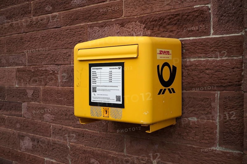 Letter box, mail box, yellow, on house wall, DHL, Deutsche Post, logo, Keplerstadt, Weil der Stadt, Baden-Württemberg, Germany