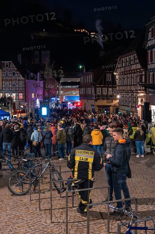 In a town centre, a crowd gathers at night in front of half-timbered houses and fire engines, carnival, Calw, Black Forest, Calw district, Germany