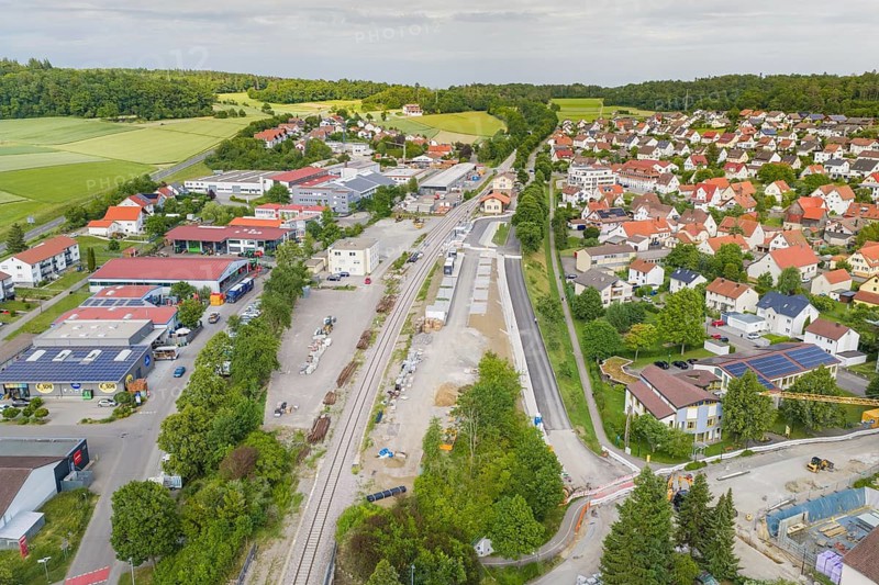 Small town seen from the air with railway tracks in the middle and surrounded by residential and commercial areas, nestled in green surroundings, Hermann Hesse Railway, Althengstett railway station, Calw district, Germany