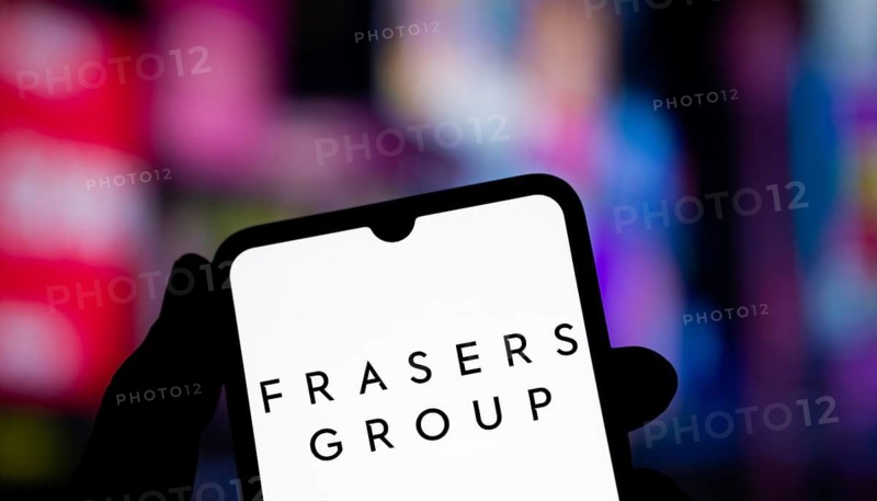 Frasers group logo is displayed on smartphone. Frasers Group plc is a British retail, sport and intellectual property company.