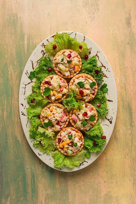 Canapes with salad, corn with crab sticks, appetizer, portioned, close-up, no people