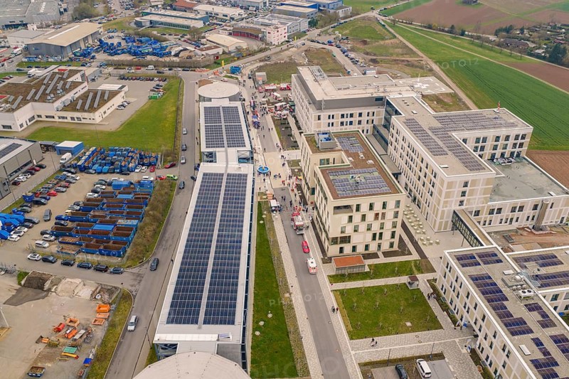 Aerial view of an industrial area with solar cells and rescue vehicles, hospital opening, Calw, Germany