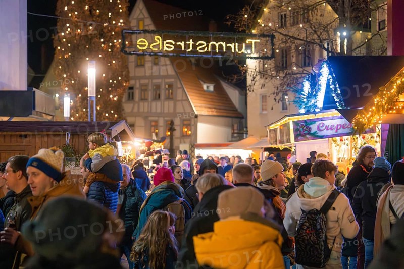 Large crowd at a brightly lit Christmas market with historical flair, Christmas market, Nagold, Black Forest, Germany