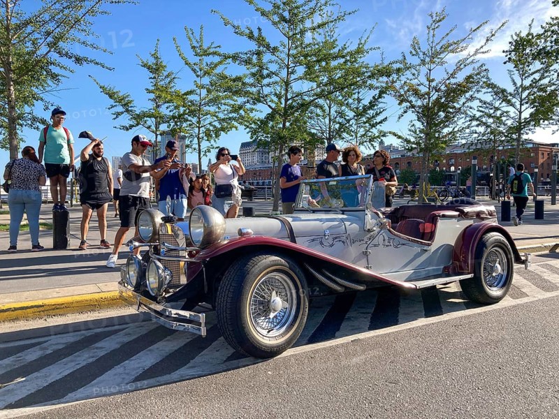 Tourists admire a 1929 Mercedes-Benz Gazelle SSK Replica in Puerto Madero, Buenos Aires, Argentina