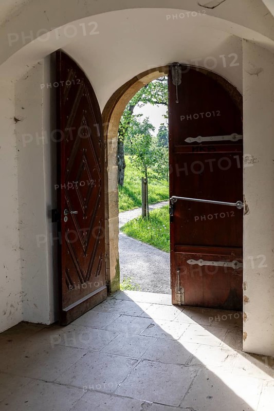 View through an open door into the greenery, Pavilion at Michaelisberg, Bamberg, Bavaria, Germany