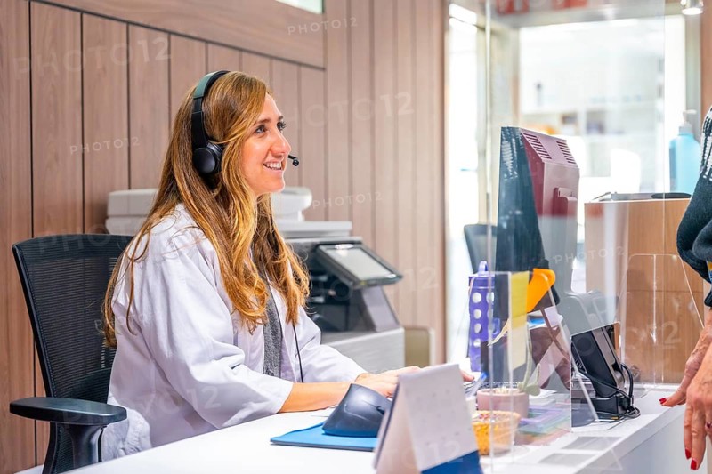 Woman in lab coat working in the reception of an hospital