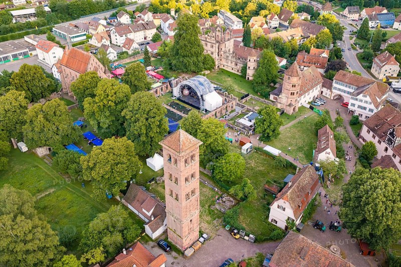 Aerial view of a historic town with old buildings and a festival in a green park, Calwer Klostersommer Festival, Hirsau Abbey, Calw, Germany