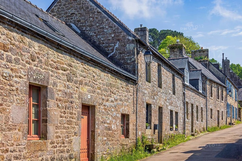 Old historic residential buildings on a street in the french village of Locronan, Locronan, Bretagne, France