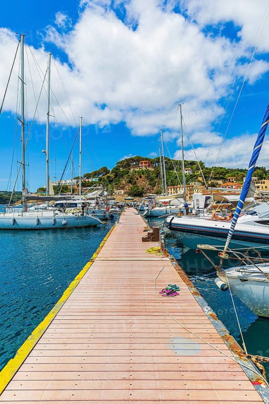 Jetty with anchored sailing yachts, harbour of Port Azzurro, Elba Island, Tuscan Archipelago National Park, Tuscany, Italy