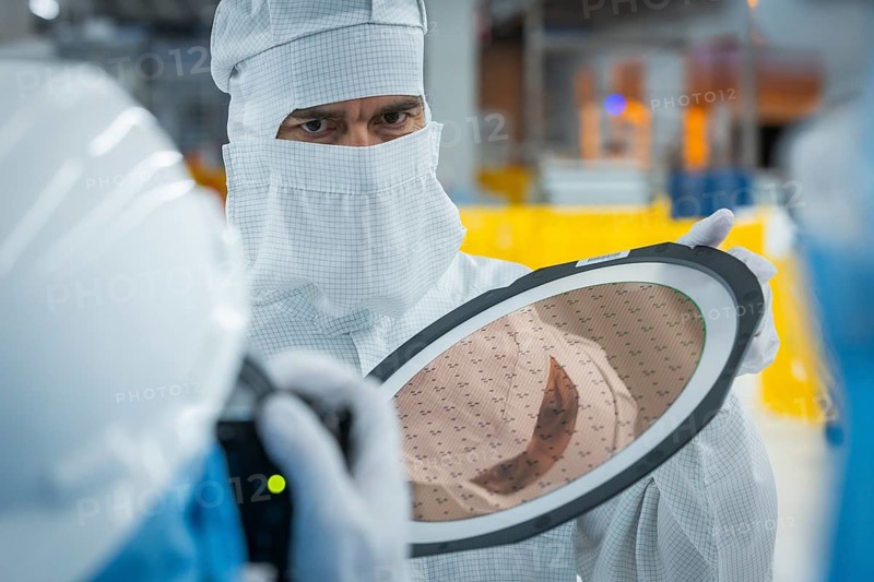 Clean room of Infineon Technologies AG's new Smart Power Fab in Dresden on June 10. The Smart Power Fab will be officially opened on July 2. With an investment volume of five billion euros, the new plant is the largest single investment in Infineon's history and one of the largest investment projects in Germany. Infineon employees with 300 mm wafers in Infineon Technologies AG's new Smart Power Fab in Dresden, Dresden, Saxony, Germany