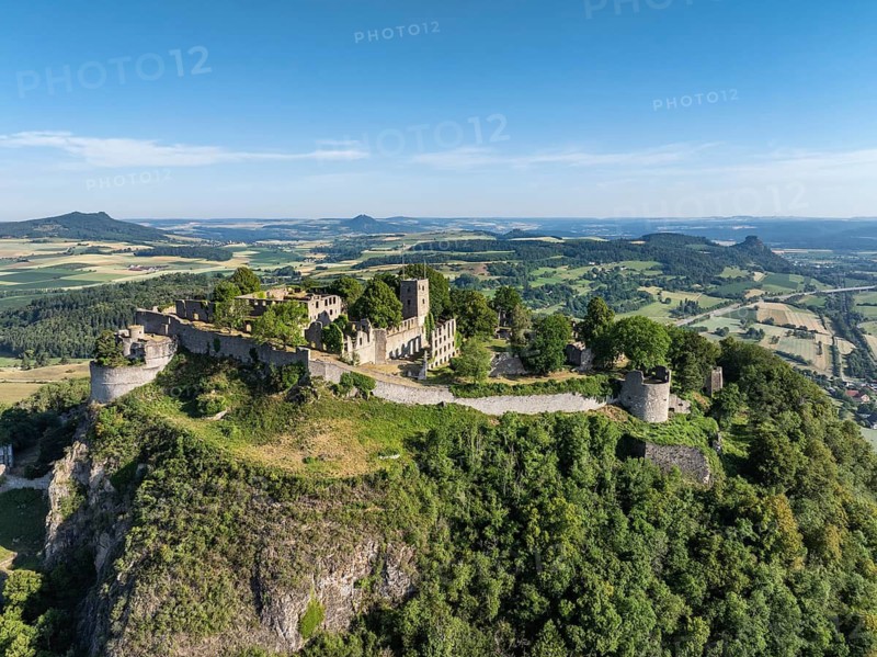 Aerial view of the Hohentwiel volcanic cone with Germany's largest fortress ruin, in the morning sun, a tourist attraction in the Lake Constance region, seen on the horizon from the left the Hegauberge Hohenstoffeln, Hohenhewen, Mägdeberg and Hohenkrähen, Hegau, Konstanz district, Baden-Württemberg, Germany