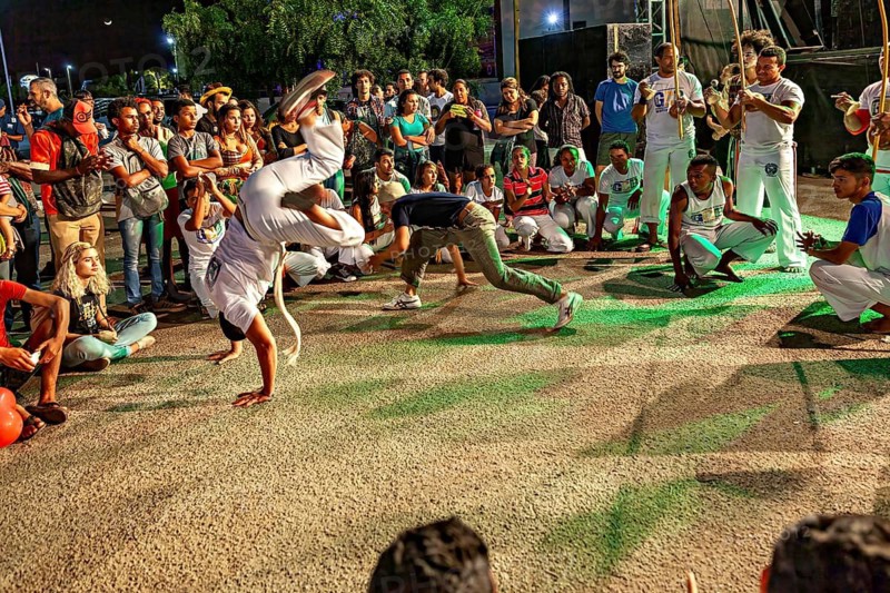 Dynamic capoeira movements in the midst of an interested crowd, The Capoeira battle dance at a small festival in Petrolina Brazil