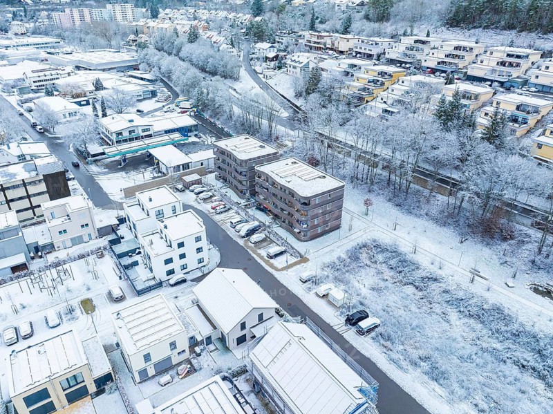 Bird's eye view of a snow-covered town with blocks of flats and streets, Nagold, Black Forest, Germany