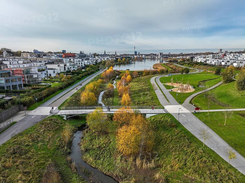 Dortmund, North Rhine-Westphalia, Germany, Phoenix Lake, front of the renaturalised Emscher. The river has been transformed into a near-natural body of water, flood protection and biodiversity through newly designed floodplains. A former industrial wasteland of 99 hectares was transformed into residential, work and leisure areas and 24 hectares of lake surface. In the event of heavy rainfall, the lake acts as a rainwater retention basin. Following the construction of a parallel sewer, the Emscher is now free of wastewater, having previously been an open, above-ground wastewater sewer, combined sewer with surface water and wastewater. The Phoenix Lake, a showcase project for structural change, is an artificial lake on the site of the former Phönix Ost steelworks in Dortmund's Hörde district