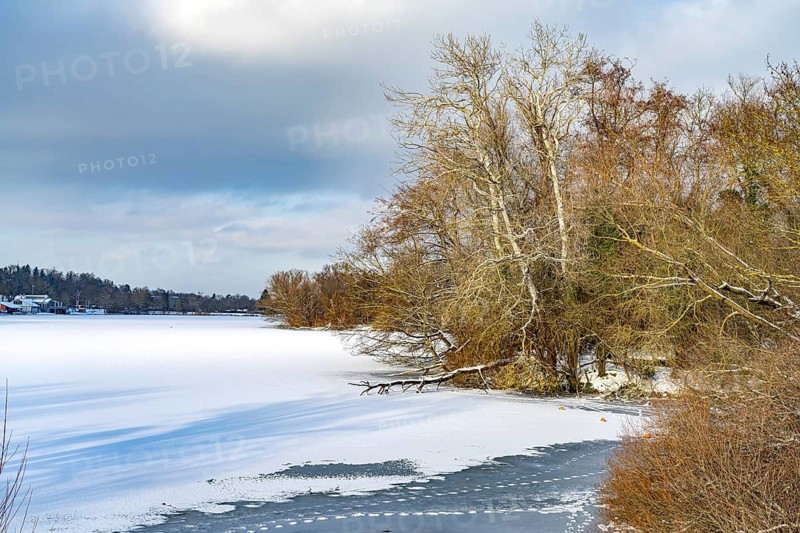 The frozen and snow-covered Kiessee lake in Göttingen, Lower Saxony, Germany