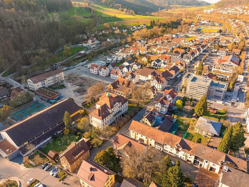 Small town from the air with colourful roofs and many trees in a sunny spring landscape, Nagold, Black Forest, Germany