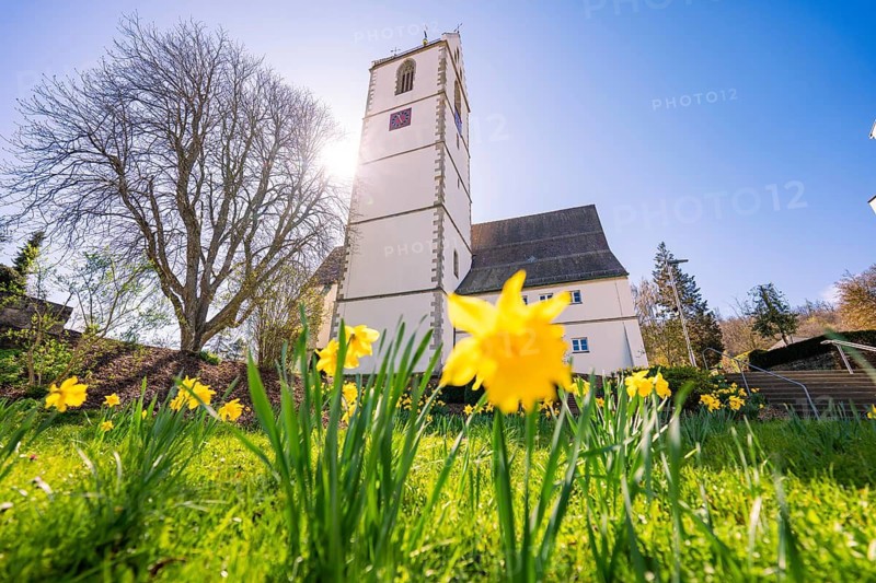 Easter bells in a meadow in front of a church in bright sunshine, Aidlingen, Böblingen district, Germany
