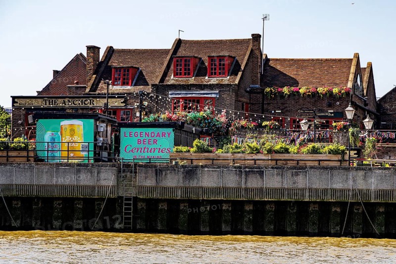 The historic Anchor pub with its riverside terrace on Bankside, overlooking the River Thames in Southwark, London, England, United Kingdom