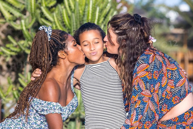 A joyful lesbian family cherishing love and unity, showcasing a nurturing and supportive environment. Captures the essence of diversity, identity, and pride