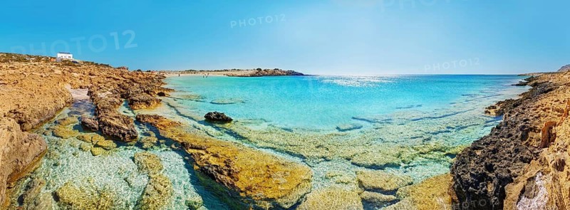 Rocky coast at Diakoftis sandy beach with crystal clear water, surrounded by quiet, unspoilt nature, Diakoftis beach, Karpathos, Greece