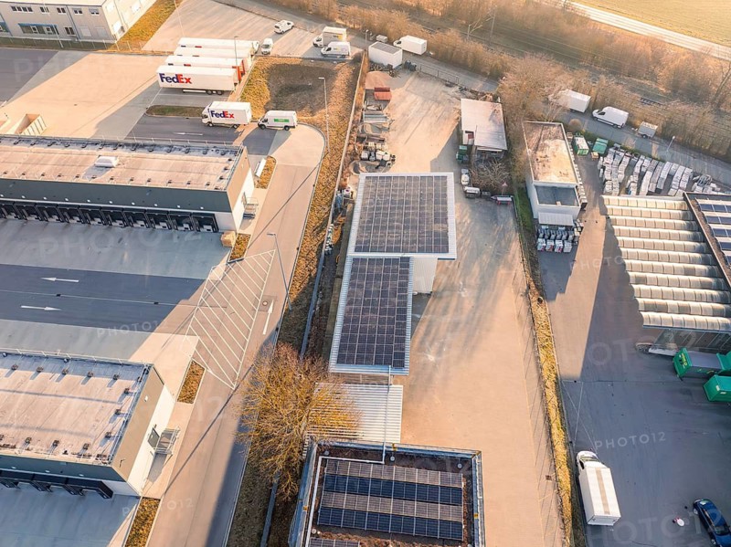 Industrial area with solar panels, trucks and storage areas in a rural area, Bauhof, Nufringen, Germany