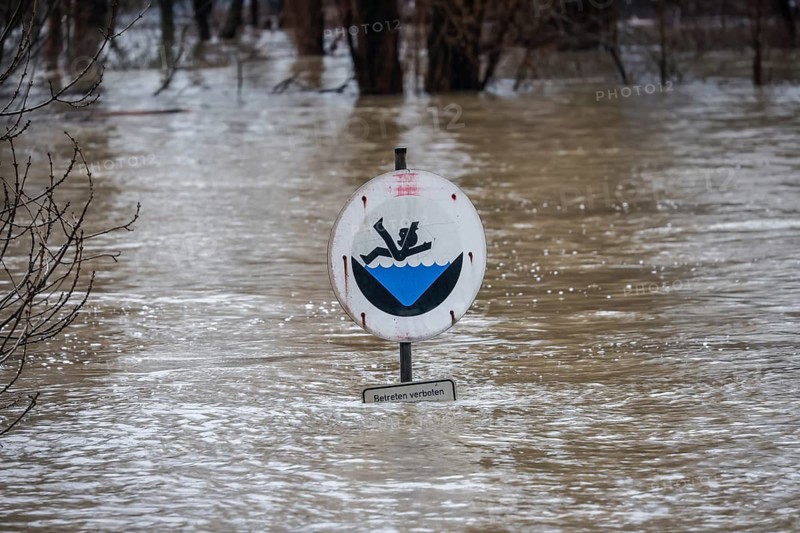Duisburg, North Rhine-Westphalia, Germany - High water on the Rhine, trees are under water on the dyke in the Marxloh district