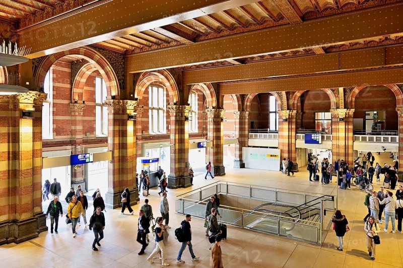 Interior view of Centraal Station, Central Station with flag, Amsterdam, Netherlands