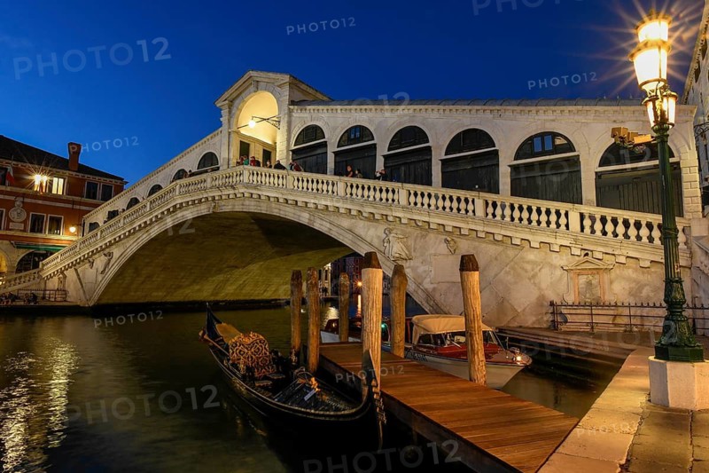 Gondolas on the Grand Canal in front of the Rialto Bridge, blue hour, Venice, San Marco district, Veneto region, Italy