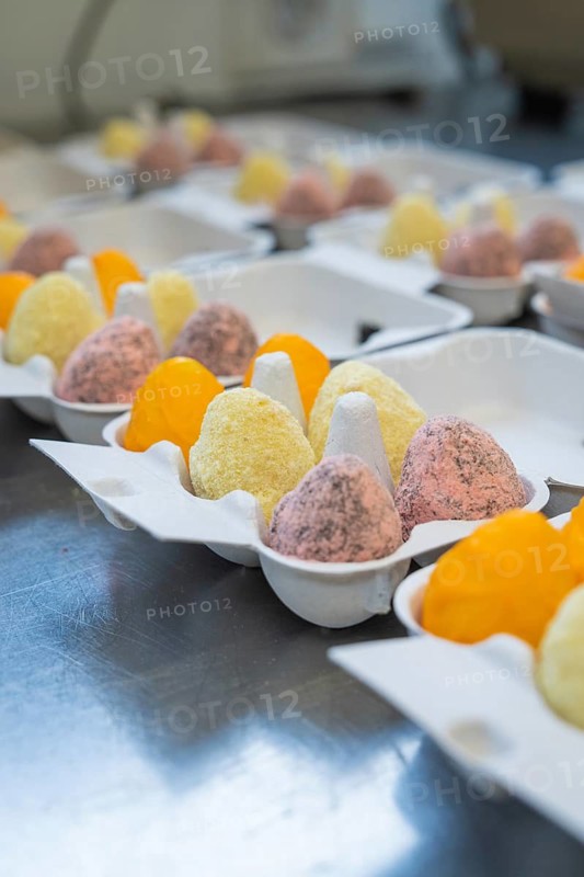 Colourful fluffy eggs in different colours in an egg carton in a kitchen, Easter baking and chocolate icing at Haselstaller Hof, Gechingen, Black Forest, Germany