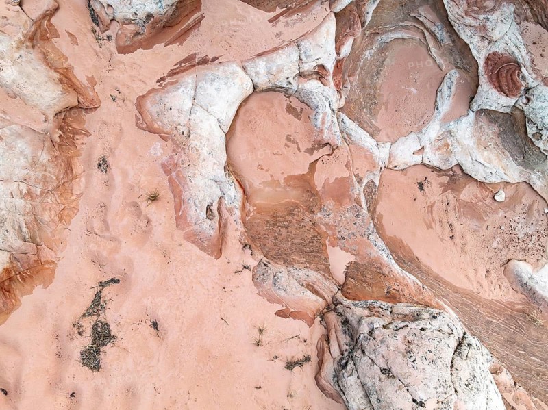 Aerial view of stunning red desert textures showcasing unique rock formations and natural patterns. The intricate layers and earthy tones highlight nature's artistry