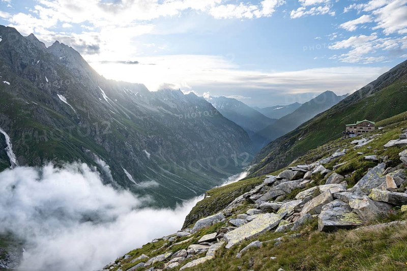 Atmospheric mountain landscape, clouds forming in a mountain valley in the evening light, Floitengrund valley, Greizer Hütte, Berliner Höhenweg, Zillertal Alps, Tyrol, Austria