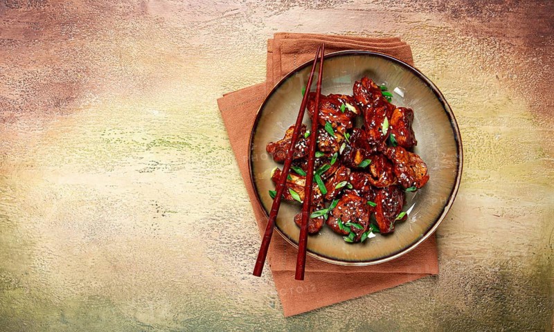 Yakitori chicken kebab, on a plate, with green onions and sesame seeds, top view, no people